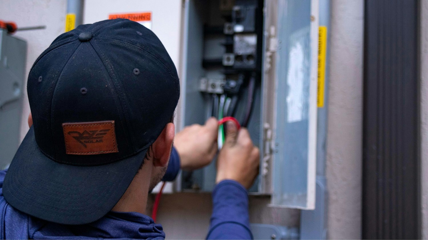 Electrician working inside a DB board